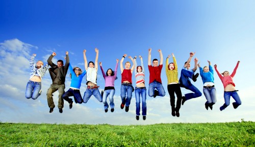 Big group of young jumping people with hands up.